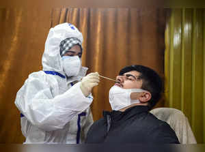 Srinagar: A healthworker conducts COVID-19 testing at a government department, i...