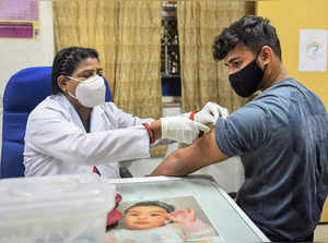 New Delhi: A health worker administers a dose of COVID-19 vaccine to a teenager,...