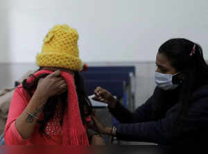 A woman reacts as she receives a dose of the COVISHIELD vaccine against the coronavirus disease (COVID-19), at a vaccination centre in New Delhi