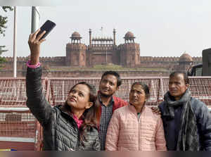New Delhi: Tourists take a photograph in front of Red Fort which is closed due t...