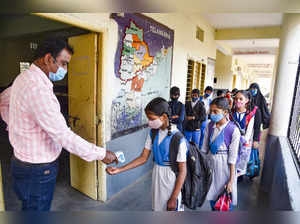 Hyderabad: Students arrive to attend classes at a school, in Hyderabad. As per t...