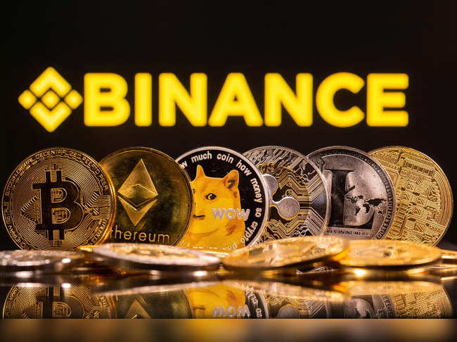 FILE PHOTO: Representations of cryptocurrencies Bitcoin, Ethereum, DogeCoin, Ripple, and Litecoin are seen in front of a displayed Binance logo