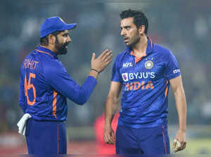 Indian bowler Deepak Chahar interacts with skipper Rohit Sharma during t...