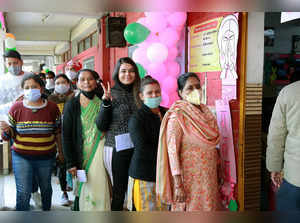 Noida, Feb 10 (ANI): Voters wait to cast their votes at a polling booth during t...