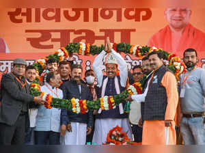 Moradabad: BJP workers garland UP Dy CM Keshav Prasad Maurya during an election ...