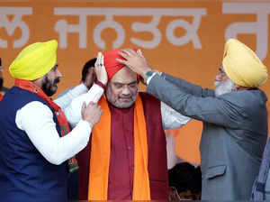Amritsar: Union Home Minister Amit Shah wears a turban during a rally ahead of t...