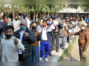 Ghaziabad, Feb 10 (ANI): Voters show ID cards while standing in queues to cast t...