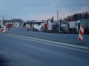 Vehicles wait to cross the border into Ukraine, in Medyka