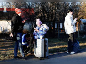 People flee from Ukraine at the Hungarian-Ukrainian border, in Tiszabecs