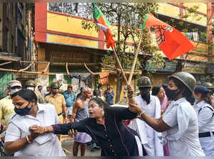 Kolkata: Police detain an activist during BJP activists' march towards Lalbazar ...
