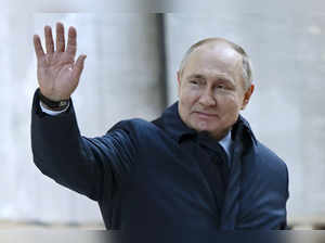 Moscow : Russian President Vladimir Putin gestures as he leaves after visit to t...