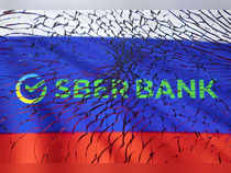 Illustration shows Sberbank logo and Russian flag through broken glass