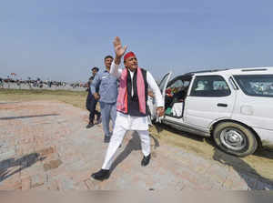 Varanasi: Samajwadi Party President Akhilesh Yadav waves at the supporters, afte...