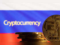 Illustration shows a representation of the cryptocurrency, word "Cryptocurrency" and Russian flag