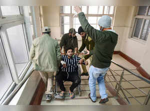 Srinagar: A civilian injured in a grenade attack by militants, being taken for t...