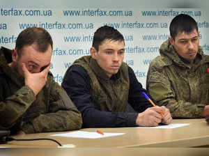 Captured Russian soldiers answer media questions at a press conference in ...