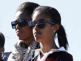 Michelle Obama and daughter Malia listen to their guide