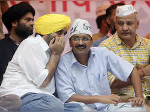 Delhi's former chief minister and Aam Aadmi (Common Man) Party chief Arvind Kejriwal listens to his party leader and lawmaker Bhagwant Mann during a rally in New Delhi
