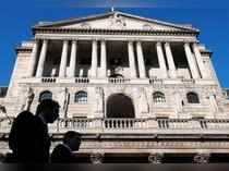 FILE PHOTO: City workers walk past the Bank of England in London