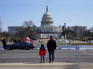 People look at U.S. Capitol, in Washington