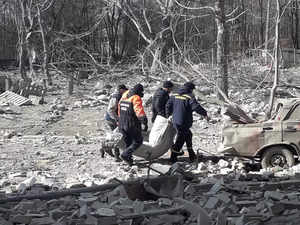 Rescuers carry the body of a person who was killed by shelling in Chernihiv