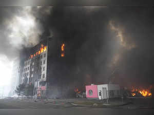 A building burns after shelling in Kyiv, Ukraine. Russian forces have esca...