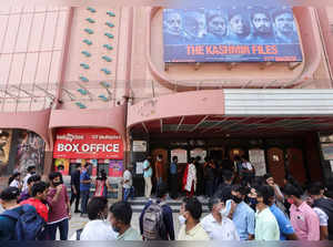 People wait in line to enter a cinema to watch the Bollywood movie "The Kashmir Files", in Mumbai