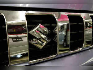 FILE PHOTO: Cars are reflected in a Suzuki car at a Suzuki Motor showroom in Tokyo
