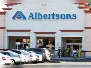 FILE PHOTO: Customers leave an Albertsons grocery store with their purchases in Burbank