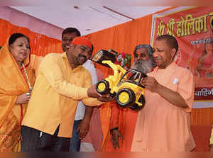 Gorakhpur: Uttar Pradesh Chief Minister Yogi Adityanath being presented a toy bu...