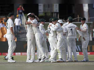 Lahore : Australia's skipper Pat Cummins, third left, and teammates congratulate...