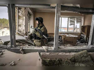 Stoyanka:  A Ukrainian serviceman stands in a heavily damaged building in Stoyan...