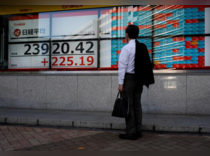 Japan's Nikkei snaps 9-day winning streak, BOJ moves limit losses