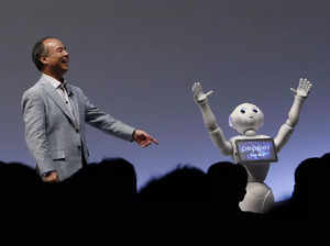 SoftBank Group Corp. Chairman and CEO Masayoshi Son reacts as SoftBank's human-like robots named "Pepper" performs during the SoftBank World 2015 event in Tokyo