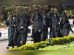 Bhopal: Burqa-clad Muslim women on their way to participate in a convention on t...