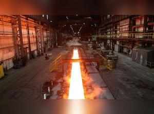 FILE PHOTO: Steam rolls off a slab of steel as it rolls down the line at the Novolipetsk Steel PAO steel mill in Farrell