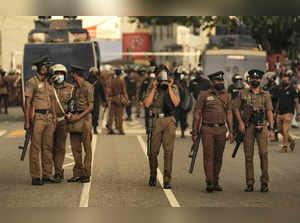 Colombo: Sri Lankan police officers secure an area during a protest demanding re...