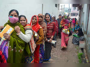 Mathura: Women, not wearing masks, stand in a queue to receive free ration durin...