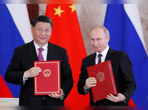 FILE PHOTO: Russian President Vladimir Putin meets his Chinese counterpart Xi Jinping in Moscow
