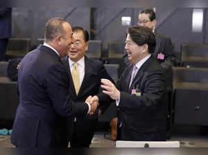 Brussels: Turkish Foreign Minister Mevlut Cavusoglu, left, greets Japan's Foreig...