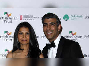 Britain's Chancellor of the Exchequer Rishi Sunak (R) poses with his wife Akshata Murthy AFP