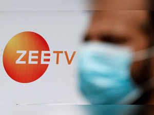 FILE PHOTO: A guard stands next to a banner of Zee television outside a film studio in Mumbai
