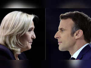 A combination picture shows portraits of Le Pen and Macron running for the second round of the 2022 French Presidential election