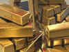 Gold flat as weaker yields, Ukraine worries counter firmer dollar