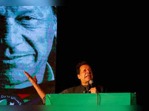 Ousted Pakistani Prime Minister Imran Khan gestures as he addresses supporters during a rally, in Karachi