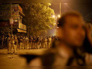 Police personnel stand guard