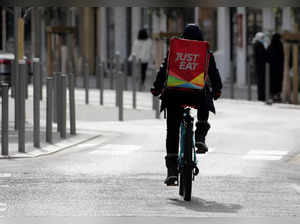 A Just Eat delivery man rides his bicycle in Nice