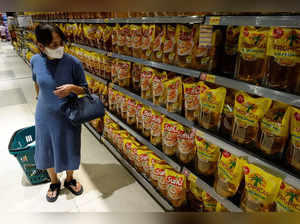 A woman shops for cooking oil made from oil palms at a supermarket in Jakarta