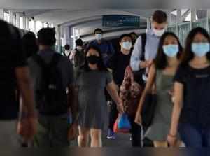 FILE PHOTO: Commuters leave a train station during the coronavirus disease (COVID-19) outbreak, in Singapore