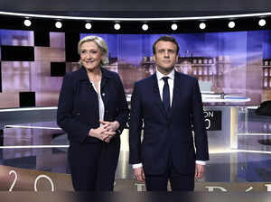 FILE PHOTO: Candidates for the 2017 presidential election, Emmanuel Macron, head of the political movement En Marche !, or Onwards !, and Marine Le Pen, of the French National Front (FN) party, pose prior to the start of a debate in La Plaine-Sainte-Denis